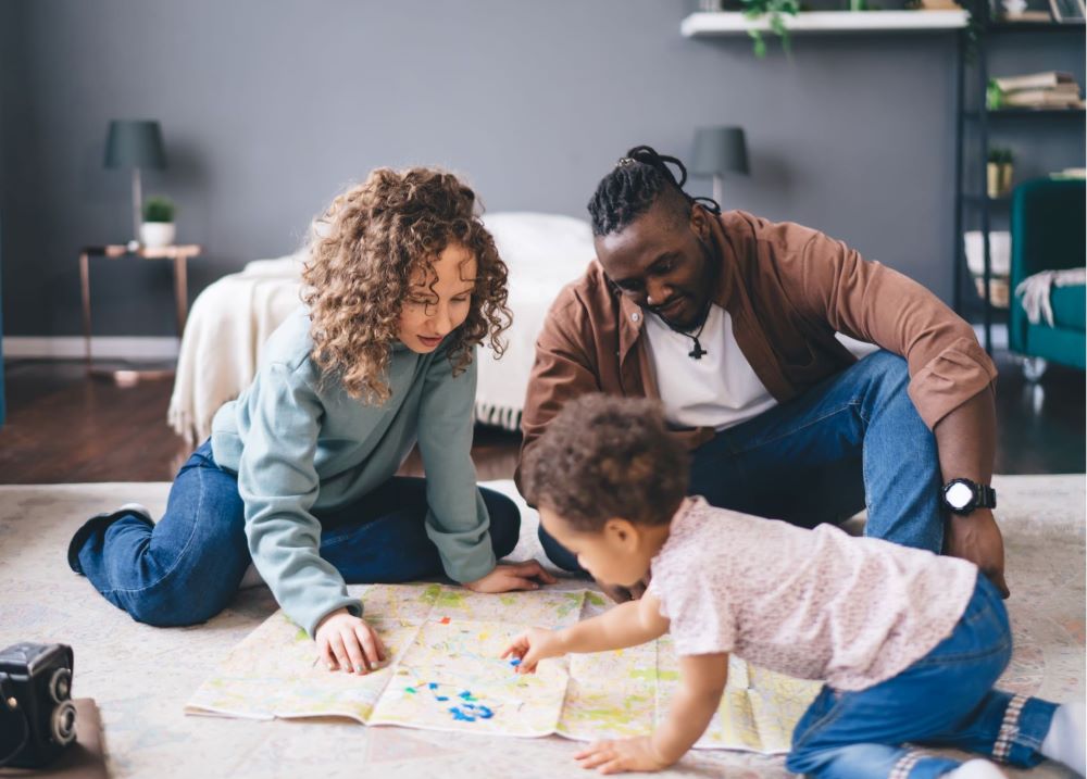 Parents playing with a child in a living room